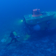 A scientist and submersible collect samples and explore the seafloor.